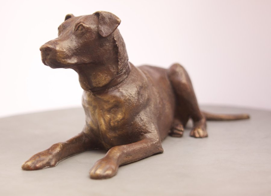 A bronze sculpture of a dog