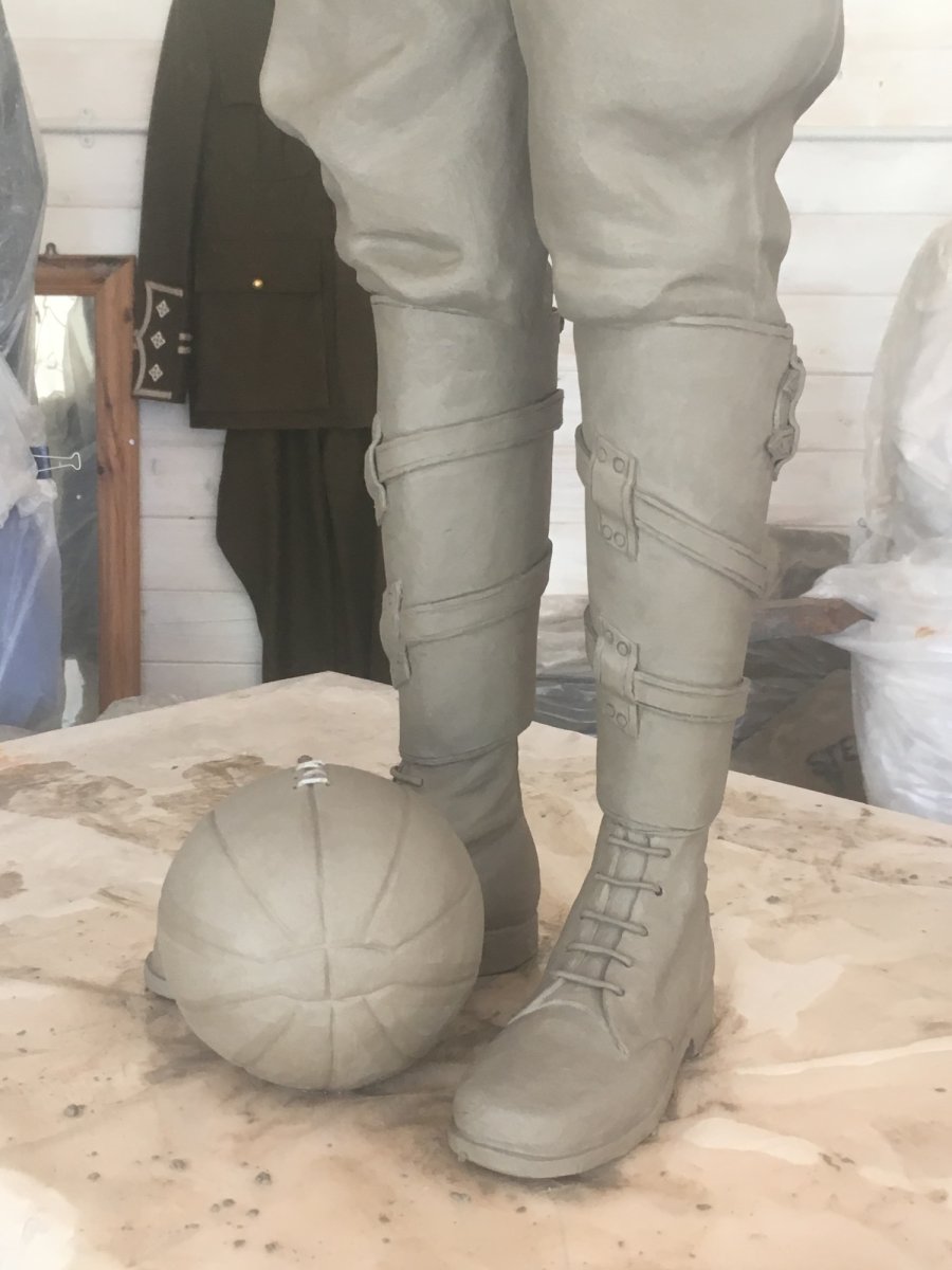 Billie Nevill clay sculpture close-up of legs and football