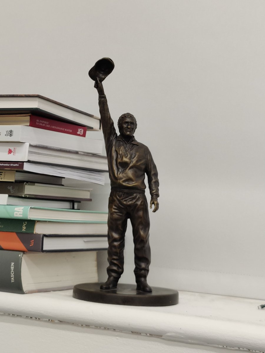 Danny Bergara statuette next to books on a shelf