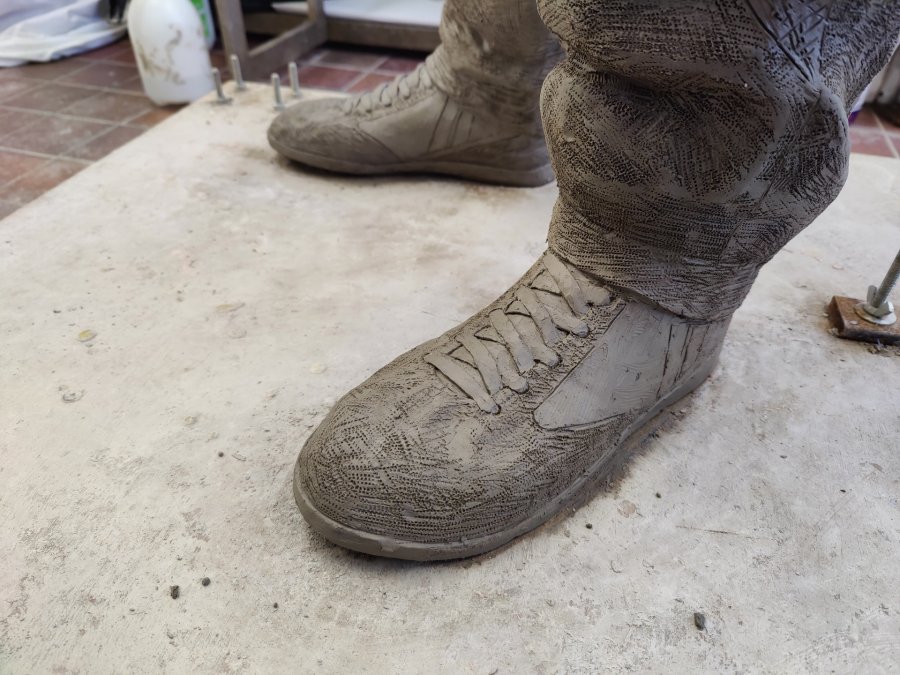 Close-up view of the foot of Danny Bergara clay sculpture