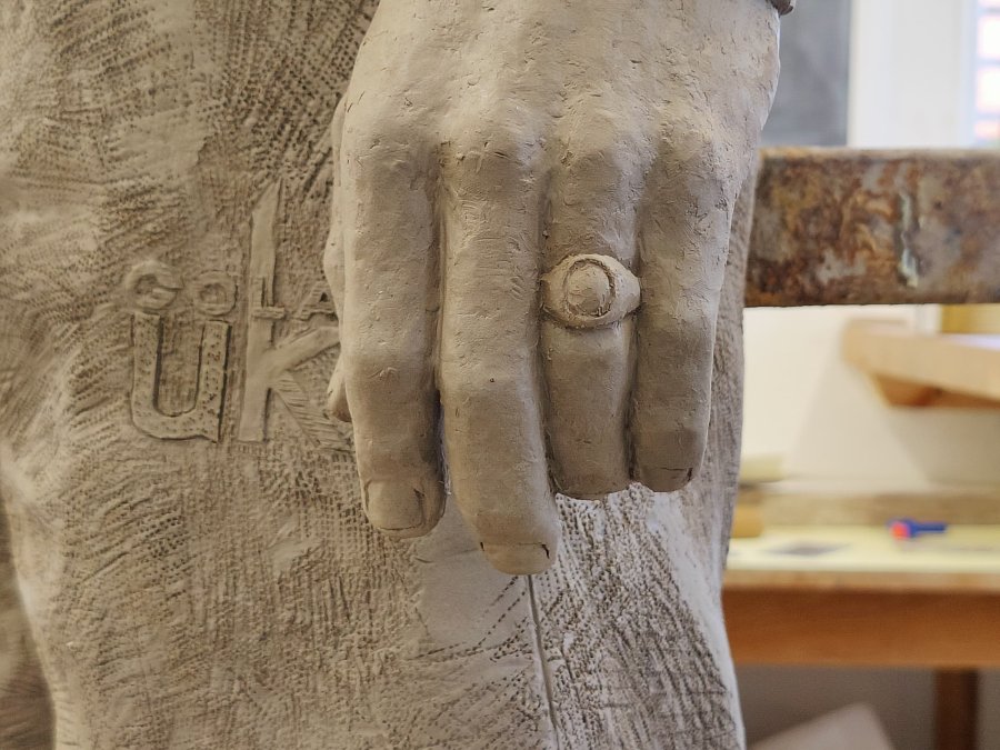 Close-up view of the hand of Danny Bergara clay sculpture