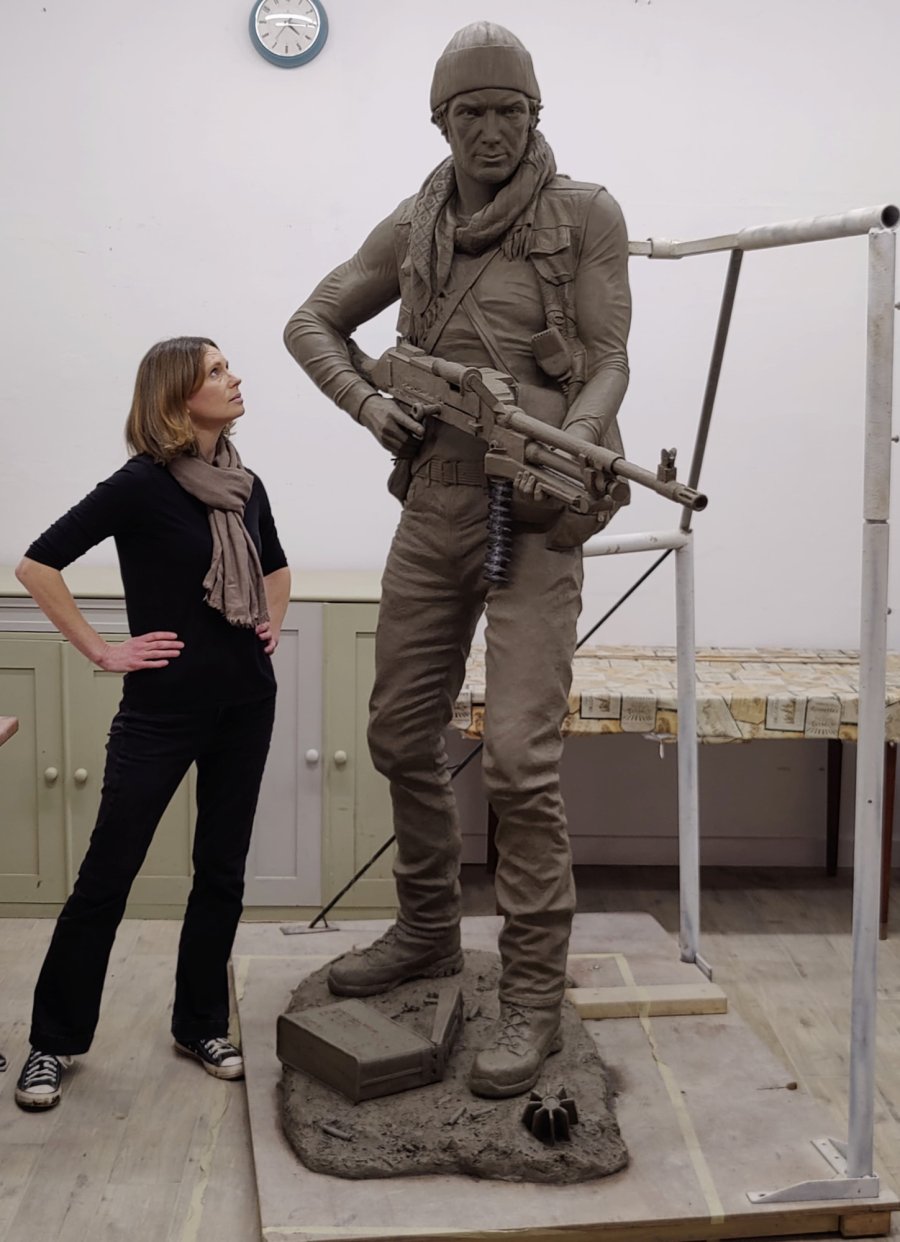 Hannah Stewart standing next to Life and a Quarter Bronze Sculpture