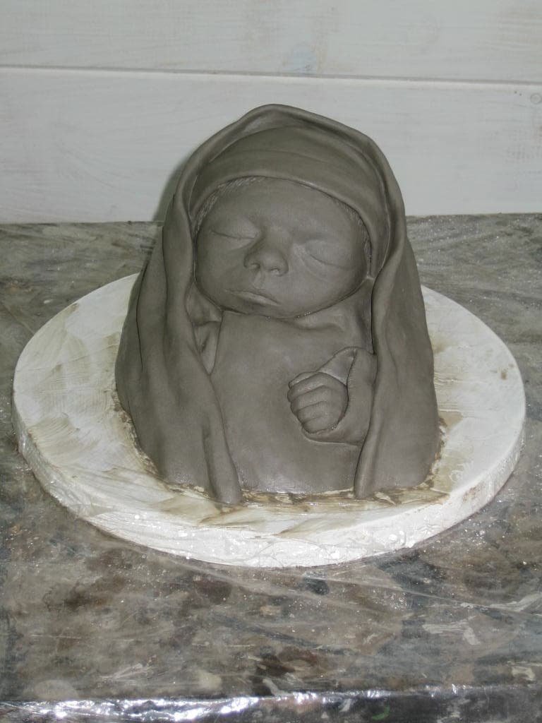 A clay sculpture of a baby