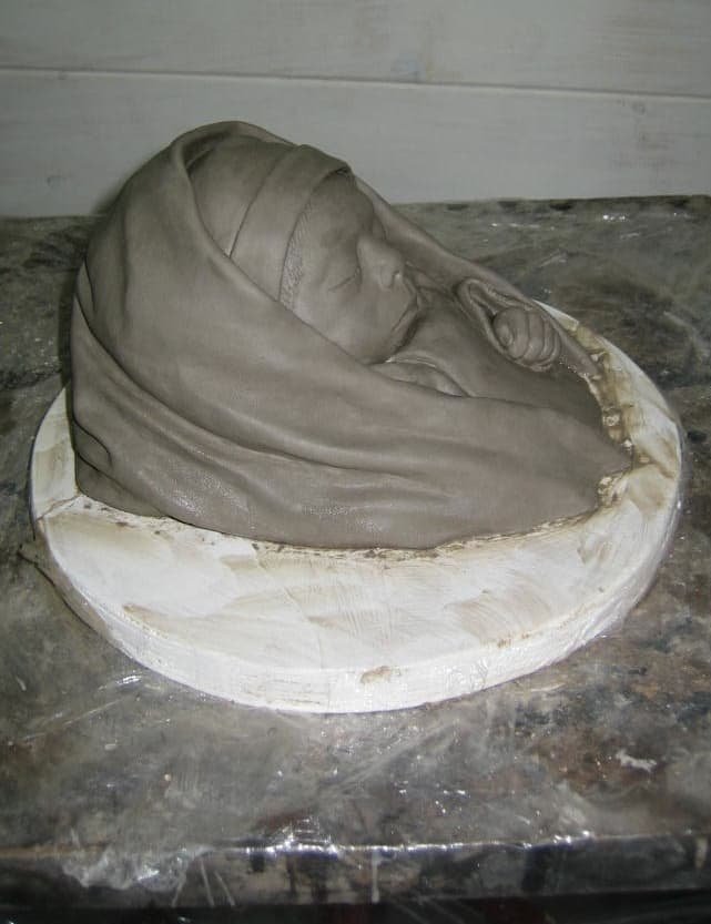 A clay sculpture of a baby