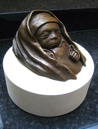 A bronze sculpture of a baby