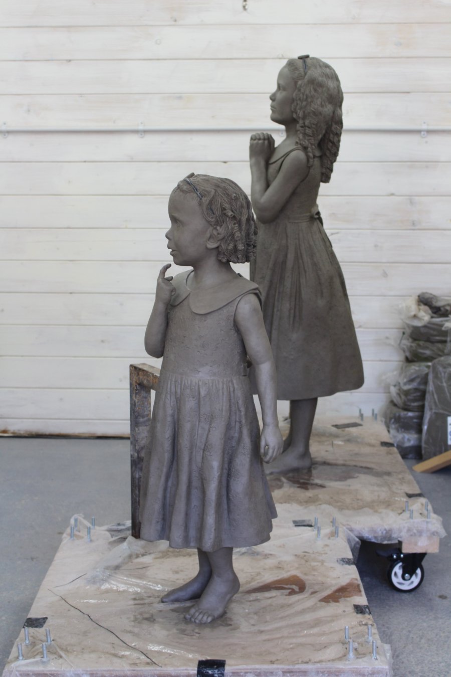 Two sisters clay sculpture